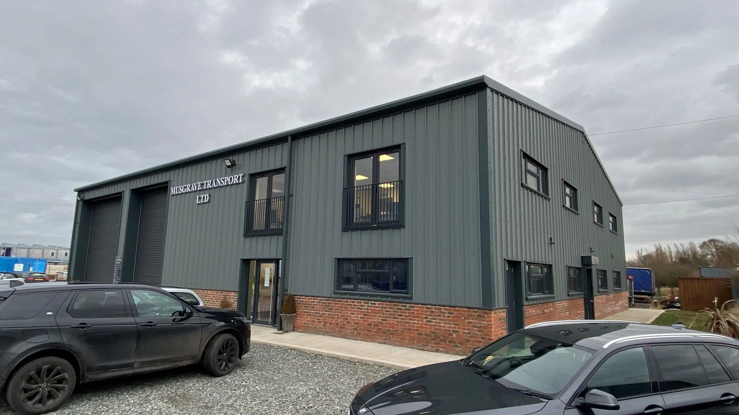 Musgrave Transport Ltd, large industrial workshop with office, glazing and Juliette balcony